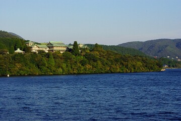 Scenic view of a traditional building by a serene lake
