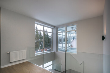 The second floor of a luxurious country house with a beautiful view of the winter landscape...