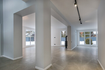 The first floor of a country house with a modern architectural design. Unfurnished. .Panoramic windows with a view of the winter landscape.