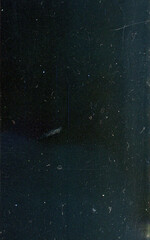 An old colored illuminated film with scratches and dust.