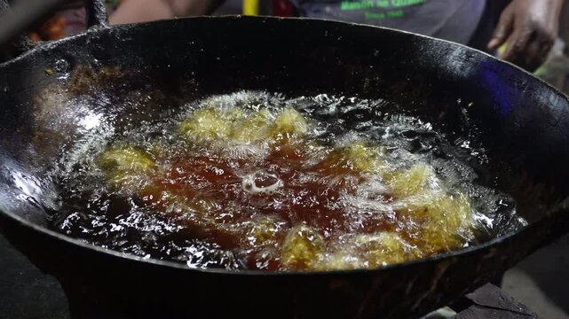 Mughlai frying on hot oil, Mughlai paratha is a popular Bengali street food 