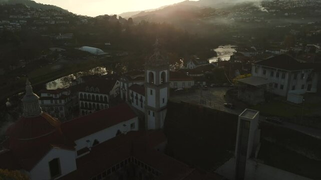 Aerial 4k video shot by drone cicling around the famous church of Igreja de S&atilde;o Gon&ccedil;alo , Church and monastery of Amarante alongside the Tamega River, Portugal shot during sunset.
