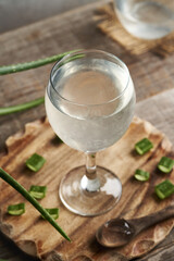 A glass of healthy aloe vera with fresh leaves