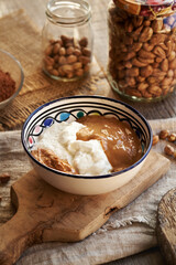 Greek yogurt, hazelnut and peanut butter in a bowl - ingredients for preparing alternative healthy sweets