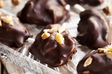 Homemade alternative healthy sweets made of greek yogurt, nut butter and maple syrup coated in chocolate