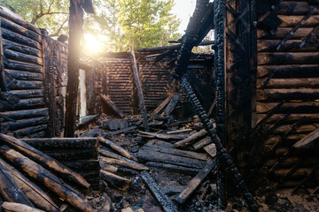 Consequences of fire. Completely burnt wooden house