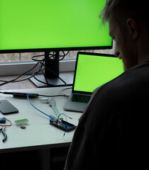 Man Practices Microcontroller Coding Close-Up