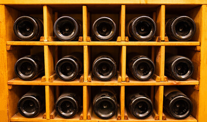 Choosing bottle of wine in cellar, closeup. NATIONAL WINE DAY