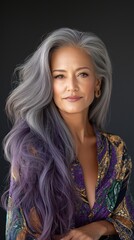 Fototapeta premium Polynesian woman in her 40s with stunning gray and purple hair, posing in an elegant patterned dress for a studio portrait