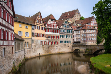 Obraz premium Historic half-timbered Houses with colorful Facades and Kocher River in Foreground in the City of Schwäbisch Hall, Germany, on a sunny Summer Day