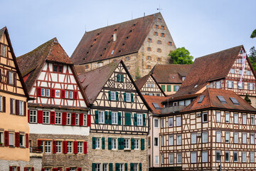 Historic half-timbered Houses with colorful Facades and Kocher River in Foreground in the City of Schw&auml;bisch Hall, Germany; Close-up