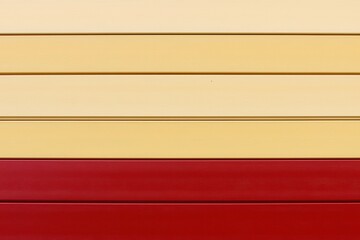 A bold gradient from crimson red to golden yellow with a subtle grain effect