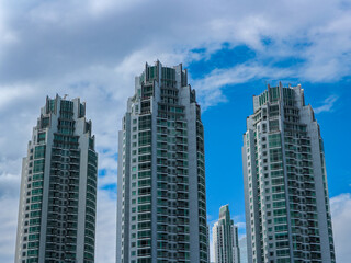 Fototapeta premium Low angle view of skyscraper with glass window and clear sky background for business and finance concept