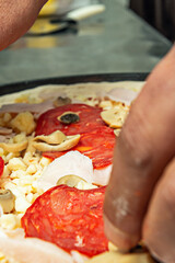 pizza is distinguished by having a thick, spongy base that is baked in a deep pan, creating a layer of melted cheese