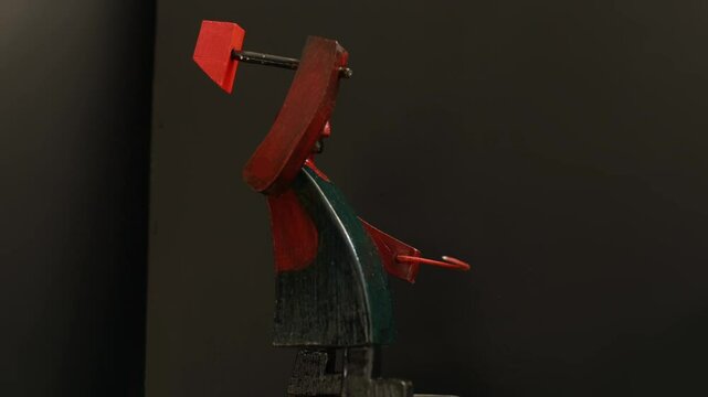 Red blacksmith swinging a heavy hammer, stop motion