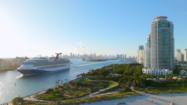 Cinematic aerial Miami Beach shot with stunning Miami skyline atmosphere as a luxurious cruise departs from the busy port, offering a perfect holiday travel getaway on the beautiful Atlantic Ocean 