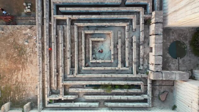 A couple in a stone labyrinth in the lands of Menorca in the Balearics