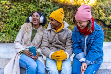 Happy multi ethnic friends laughing and enjoying winter day together outdoor
