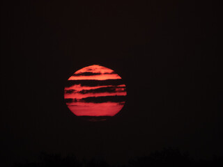 Red Sunrise with dark cloud tiger stripes