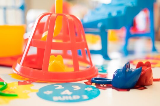 Colorful Children's Educational Game with Plastic Shapes and Pieces on Table