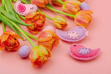Gentle Easter composition with tulips flowers and handmade felt birds. Traditional elements