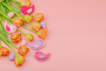 Gentle Easter composition with tulips flowers and handmade felt birds. Traditional elements