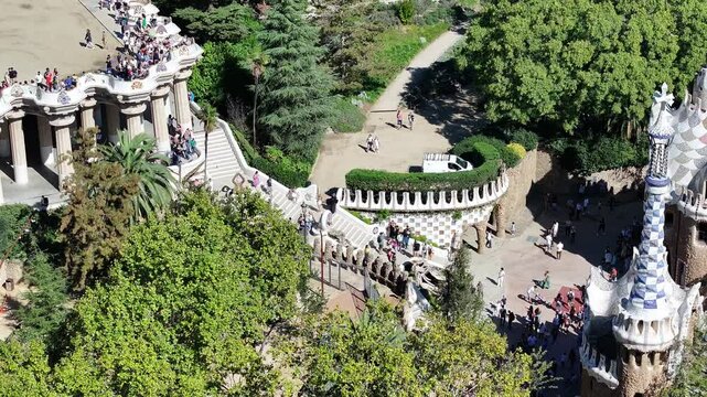 A stunning aerial view of Parc G&uuml;ell in Barcelona, Spain, showcasing Gaud&iacute;'s iconic architecture and the vibrant colors of this UNESCO World Heritage Site.