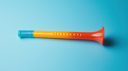 Colorful plastic party horn blower on blue background.