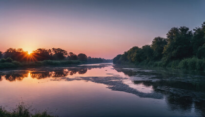 Obraz premium Sunset reflecting over calm river surrounded by lush trees in serene landscape