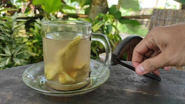 A footage shows a cup of ginger tea that has just been drunk, with a small spoon placed on it