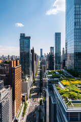 Fototapeta premium Urban Harmony: Aerial Perspective of City Life with Skyscrapers and Green Rooftops