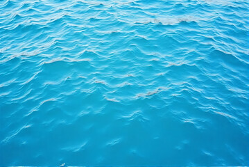 Obraz premium Background of a blue water surface with waves texture and wallpaper design
