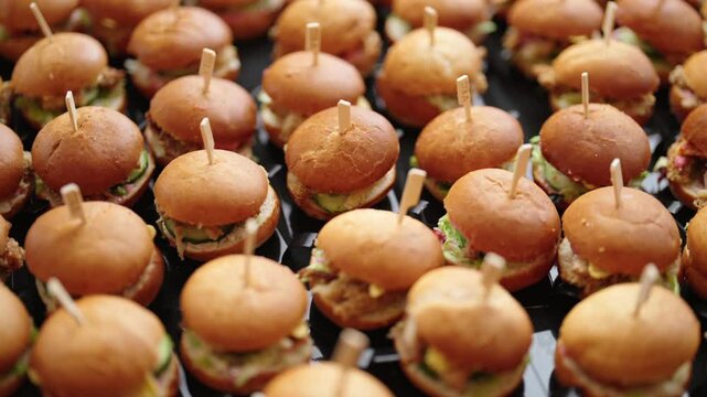 mini vegetarian hamburgers arranged in rows, catering service at the event