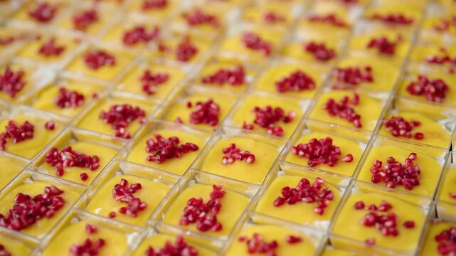 catering desserts with mango mousse and pomegranate seeds