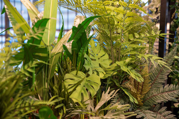 Obraz premium Artificial lush indoor plant arrangement with a mix of greenery