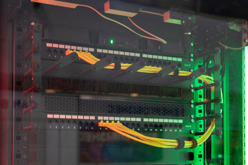 Network server with multiple yellow cables and green LED indicators