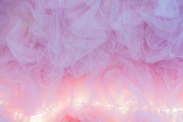 Decorative background made of pink tulle with backlighting