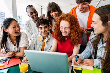 Young group of teenage students working together on laptop at campus school. Education lifestyle concept