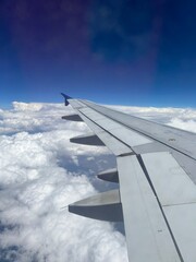 view from airplane window up in the clouds