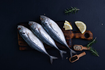 Raw mackerel, seafood, ready to cook on black background