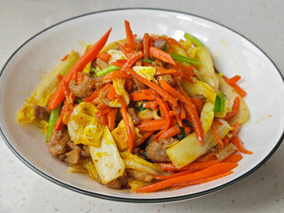 fresh orange carrot scrambled with with vegetables in the bowl for eating
