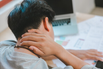 Man feeling exhausted and depressed sitting in front of laptop. Work burnout syndrome.