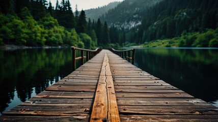 Fototapeta premium Wooden pier extending into a serene lake surrounded by lush green forest.