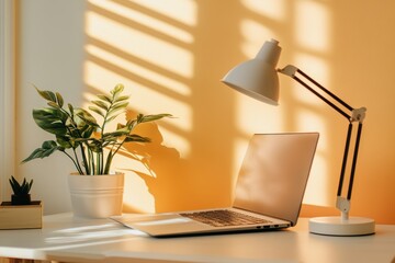 Fototapeta premium Bright and Cozy Home Office with a Laptop, Desk Lamp, and Green Plants Bathed in Warm Natural Light Creating an Inviting Work Environment