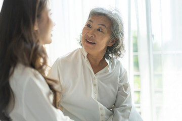 Portrait of enjoy happy love asian family senior mature mother and young daughter smiling play laughing and having fun together at home, care, elderly, insurance.happy family and Mother Day concept