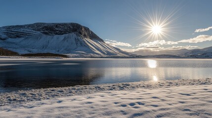 The sun shines brightly on a tranquil snowy mountain landscape, highlighting the pristine winter beauty.