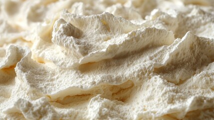 A close-up view of whipped cream showcasing its fluffy texture and peaks.