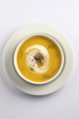 Pumpkin soup. Vegetarian soup with pumpkin seeds in ceramic bowl