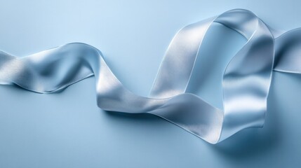 A delicate silk ribbon flowing in abstract motion, set against a calm, soft blue backdrop, evoking elegance and tranquility.