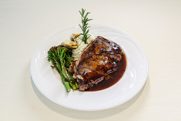 A plate of food with meat and vegetables on it